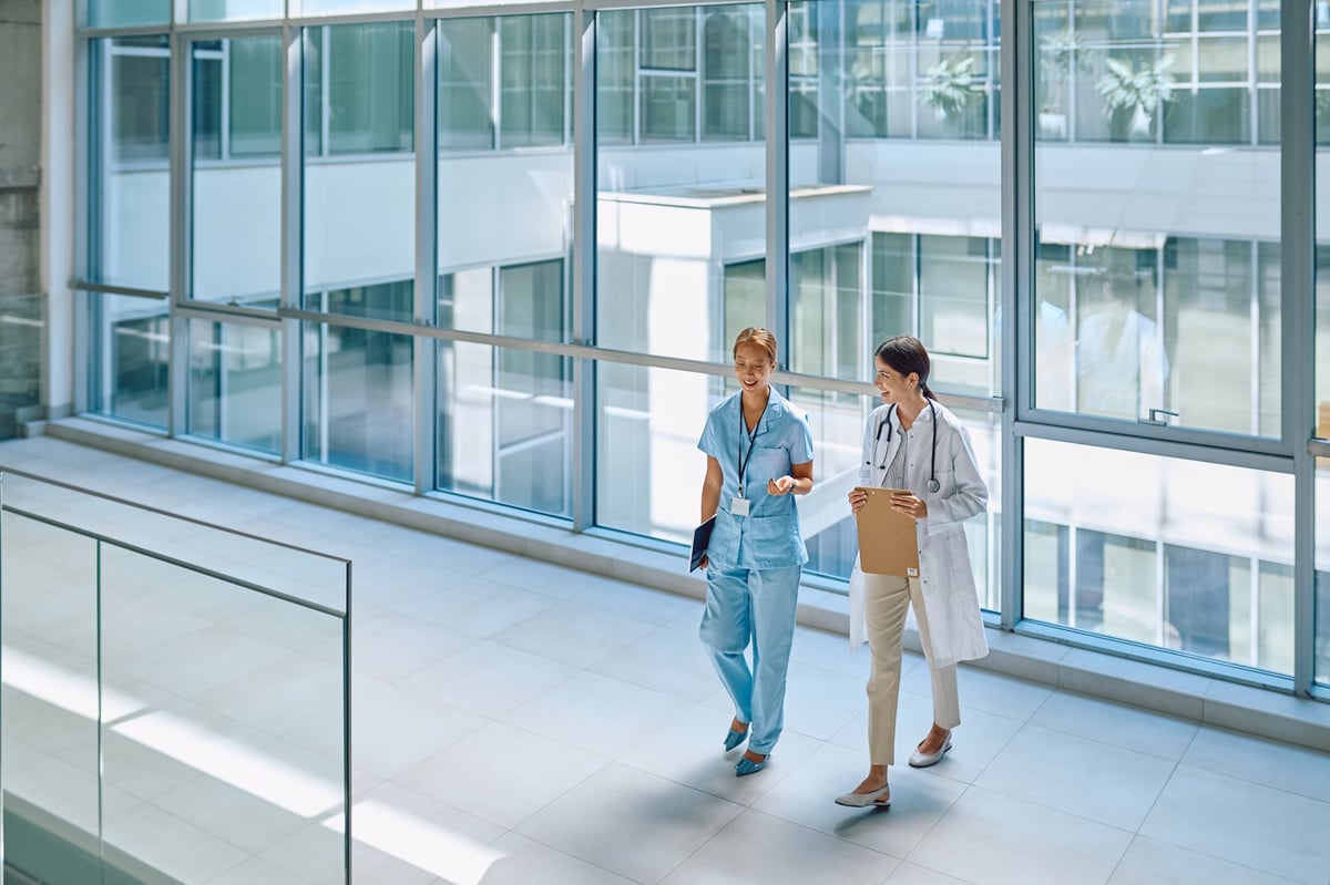Modern bright hospital corridor with medical professionals