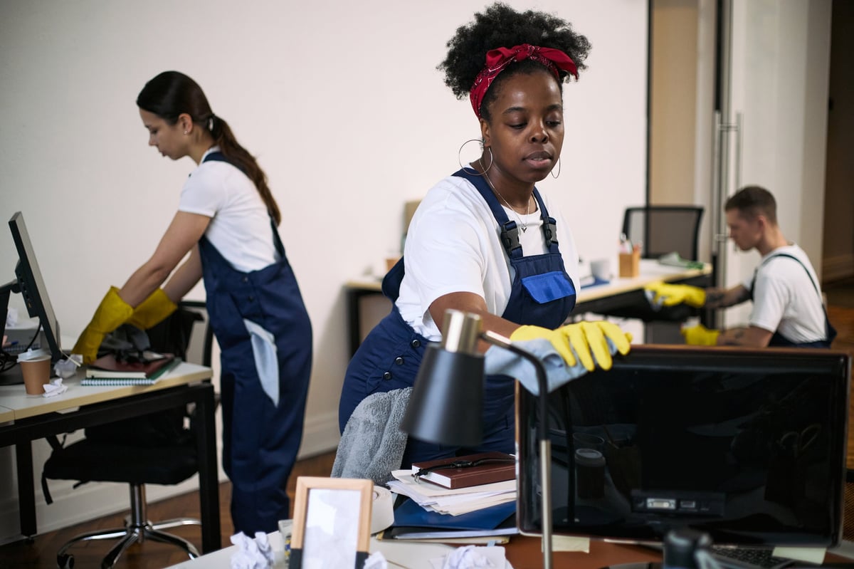 Professional cleaning team working in a modern corporate office